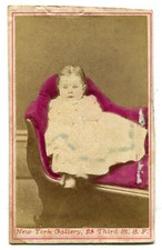 TODDLER POSED ON COUCH. TINTED CDV. N.Y.