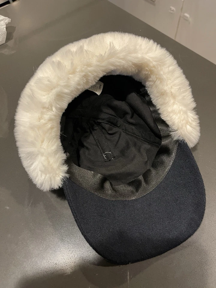 knitted winter hat with a visor and white faux fur ear muffs and pom-pom New - Image 3 of 4