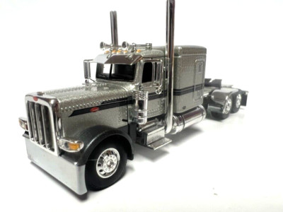 DCP / FIRST GEAR 1/64 SCALE 389 PETERBILT FLAT TOP,  SILVER WITH GRAY STRIPE