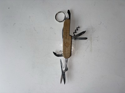 Modern Multi-tool Knife With A Wooden Handle That Is Engraved 