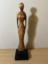 decorative hand-carved wooden statue of a female figure,
