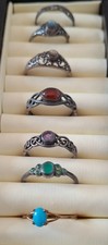 A selection of vintage metal rings with coloured stones. Fair condition for age.