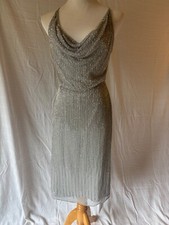 Adriana Papell Evening 10, silver beaded dress with straps cross in back.