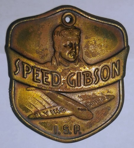 A 1930'S SPEED GIBSON FLYING CORPS I.S.P. BRASS PINBACK BADGE-ORIGINAL