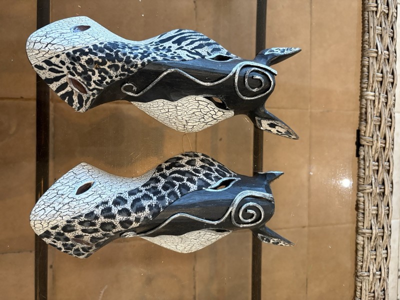 Set of 2 wooden animal masks with unique designs, each featuring a different