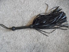 Whip flogger black leather 26 inches long 100 strands.