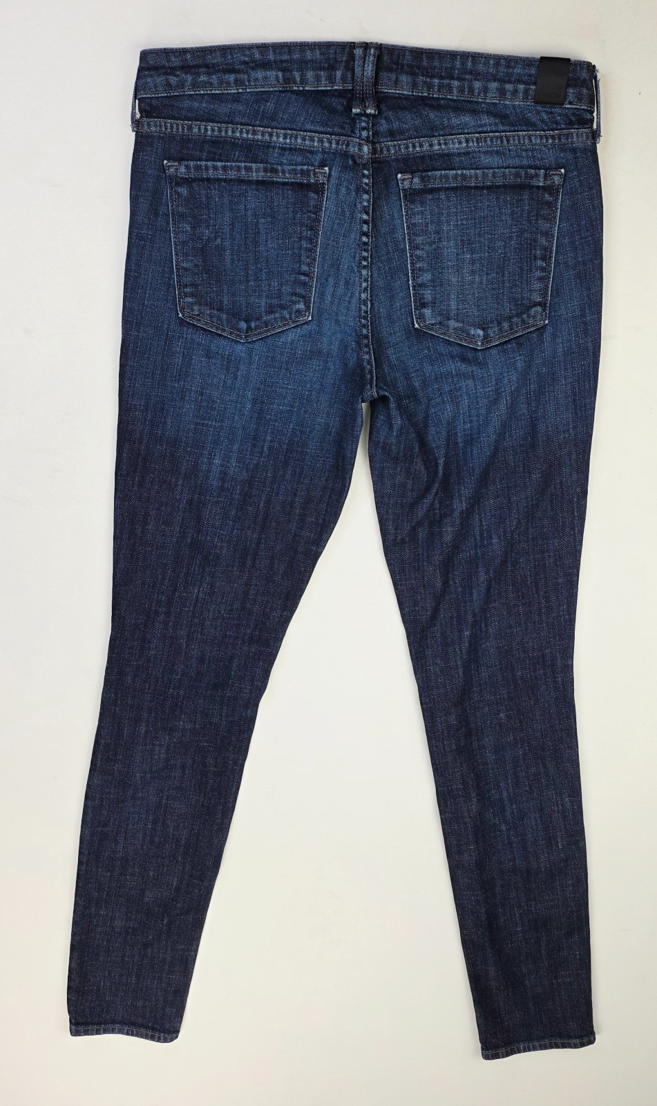 Back view of Vince Dylan skinny women’s 28X31 blue denim jeans with five pockets and belt loops made in the USA.