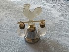 Vintage salt and pepper shakers hanging from a lucite rooster and bell — photo 1