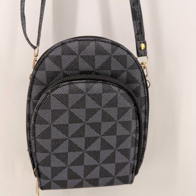 This is a round, monogrammed shoulder bag with 3 compartments in black.