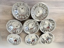 A stack of modern stainless steel bowls made by Hijos de C. Greco S.A.