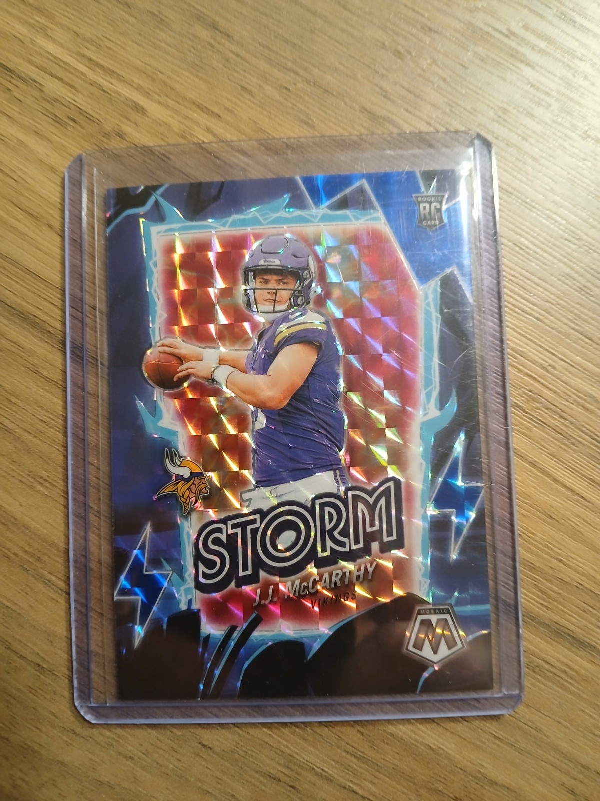 2024 Panini Mosaic J.J. McCarthy Rookie Storm Blue Prizm/#99 Vikings