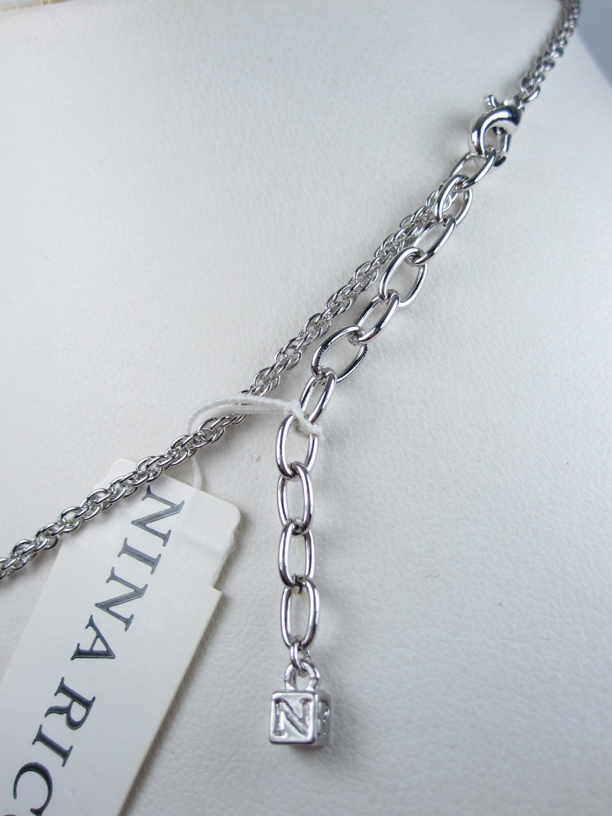 Nina Ricci Rhodium Plated Pendant - Swarovski Crystals and NR Logo 16-18" - 8025