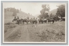 Postcard RPPC Men Riding Horses Mountain Dirt Road Scenic View Sepia Tone 1900s