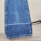 Blue denim high-rise straight leg with yellow stitching, marked by a black vertical line and white fabric fold.
