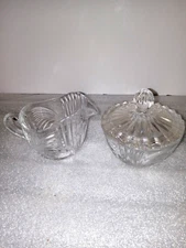 A clear sugar bowl and creamer