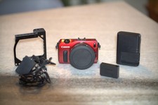 Canon EOS M Mirrorless EOS M to EF adapter, Dummy battery, Cage, and battery. 