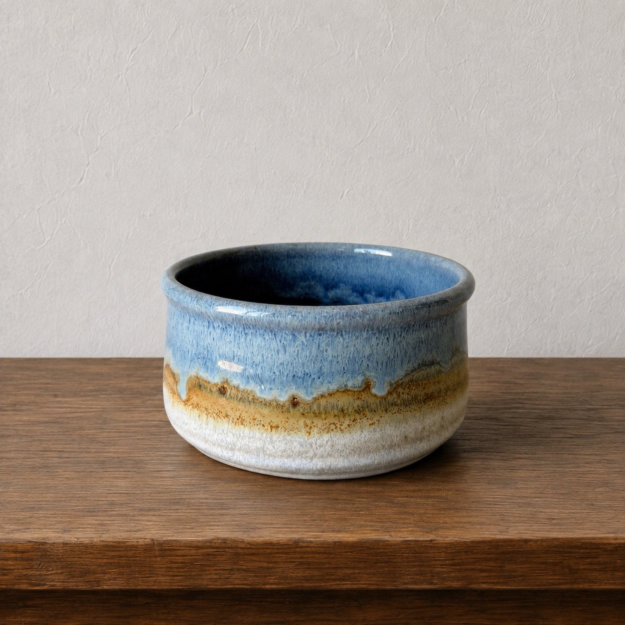 Small round stoneware trinket dish with blue drip glaze