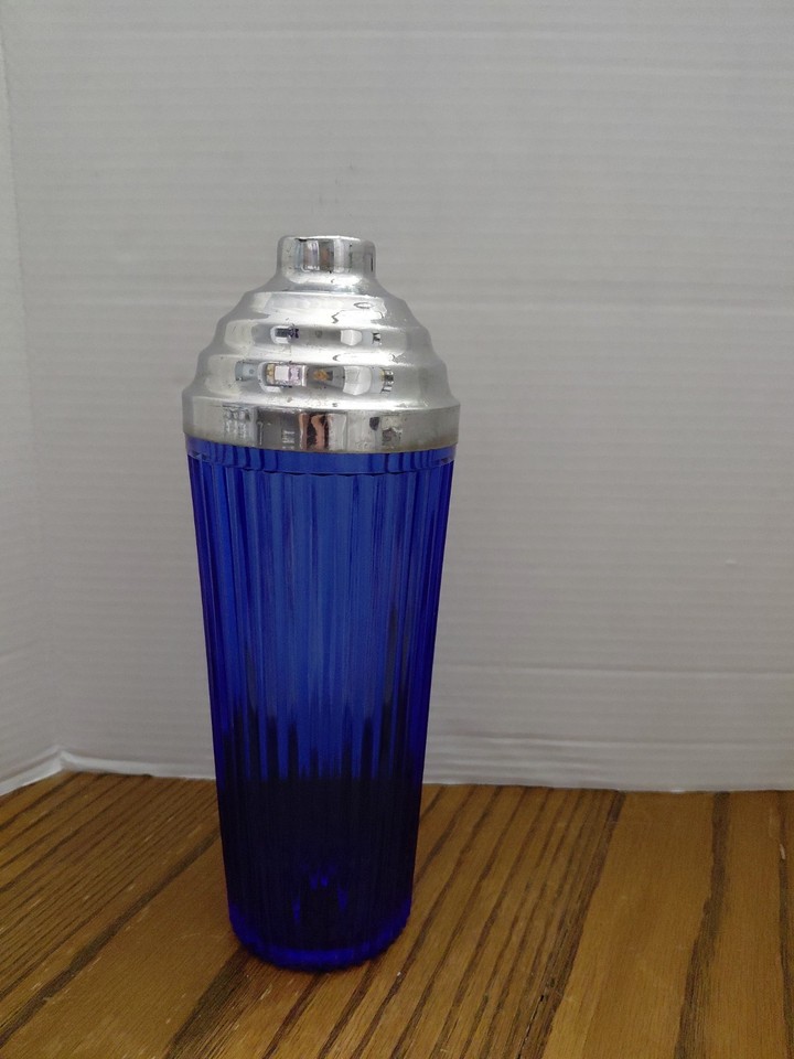 Striking cobalt blue ridged glass cocktail shaker that looks like a prop from a 1950s glamour film — genuinely rare mid-century barware eye candy.