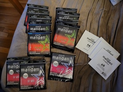 lot: twelve (12) unopened packs Curt Mangan Pure Nickel electric guitar strings