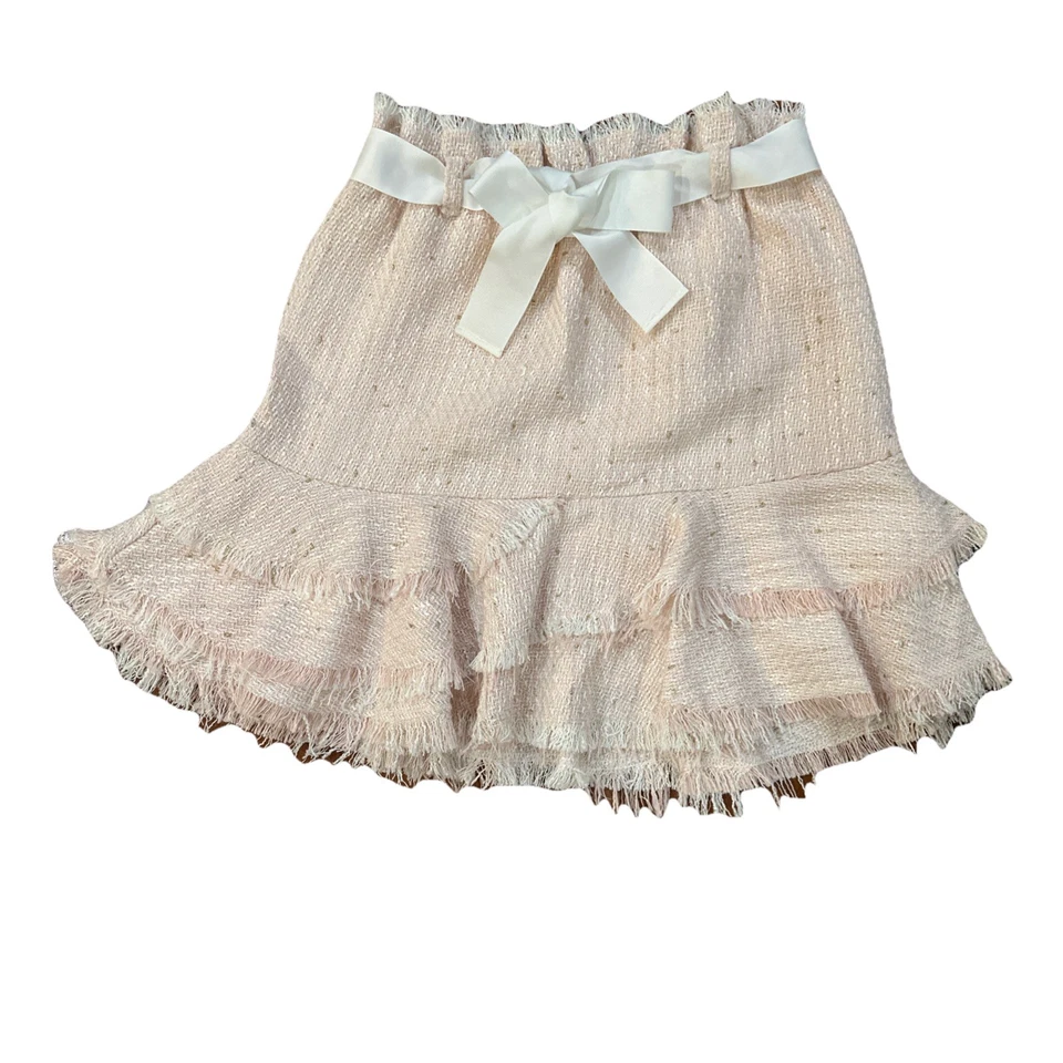 Hermosa falda de tweed rosa claro con lazo blanco Foto 2 de 4