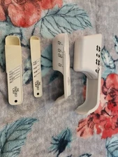 Two Pampered Chef Slide Measuring  Cups and Two Sliding Measuring Spoons