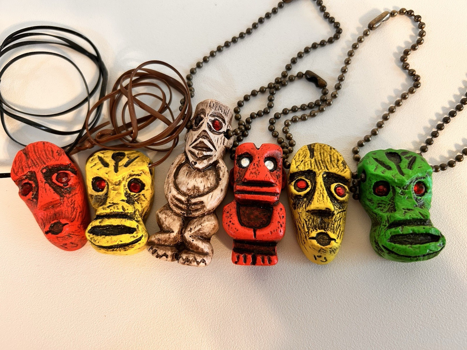 6 PCS. OF FLUORESCENT TIKI'S 3 HAVE KEY CHAINS  3 HAVE CORDS GLOW W/ BLACK LIGHT