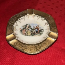 LIDO WS George Canarytone 22K Gold Crest-O-Gold Ash Tray Man With Flute And Lady