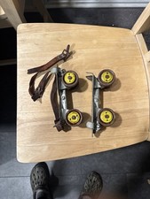 Vintage Adjustable Metal Roller Skates with Leather Straps and Yellow Wheels