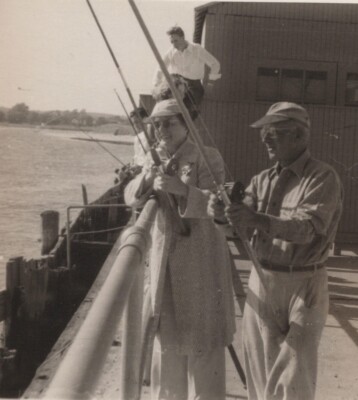 Leisurely Fishing Trip Men Dock Casting Lines Third Person Background