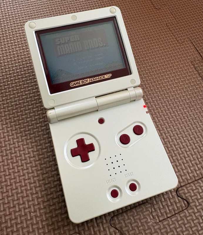 Nintendo Game Boy Advance SP console and a Super Mario Bros. game cartridge.