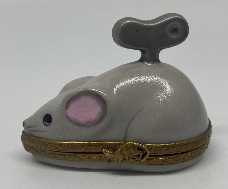 A hand-painted Limoges porcelain mouse trinket box styled like a wind-up toy — absurdly detailed French craftsmanship in a palm-sized package.