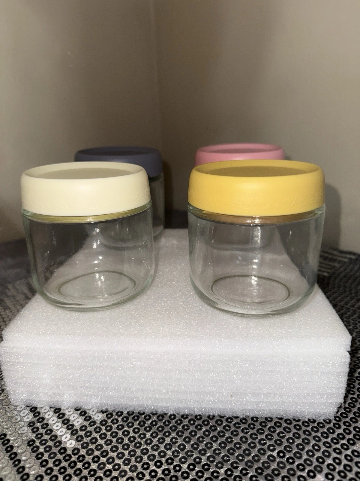 4 cute glass jars with colorful lids