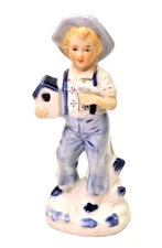 Young Boy Holding Bird and Bird House Glazed Porcelain Figurine 6.25"