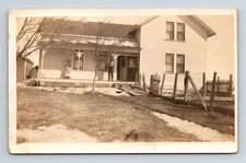 RPPC Man & Woman on Porch of Snowy Home Postcard