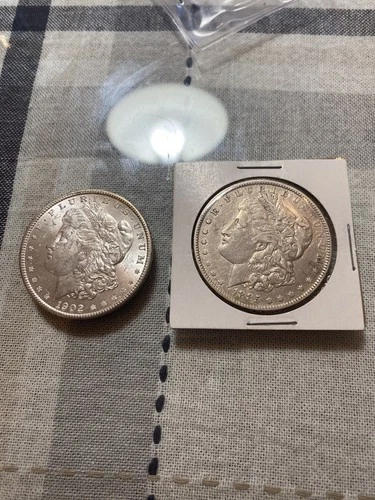 Lot of 2 Morgan silver dollars 1902 O, 1885 O: AU Very good (1902 mint state)