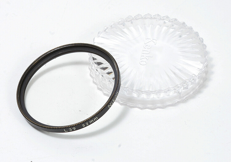 a NIKON FILTER, 52MM L39 SKYLIGHT, KENKO CASE, ONE SPECK/xxw