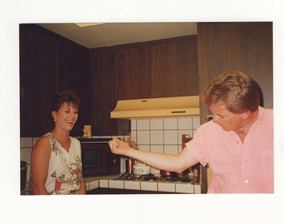 Vintage Color Snapshot Man Flexing Arm Playfully in Kitchen Candid 1990s Scene