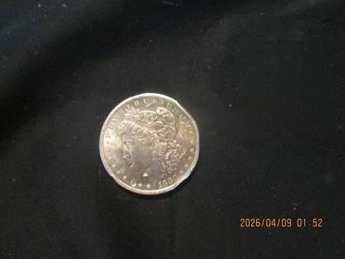 1880s Morgan silver $, 90% silver,slight bend on rim,uncirculated
