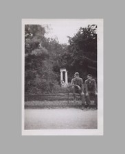 WW2 Photo U.S. Army GIs Sitting On Fence Statue In Back