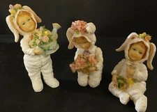 3 Children in White Bunny Suits in Different Positions with Flowers Figurines