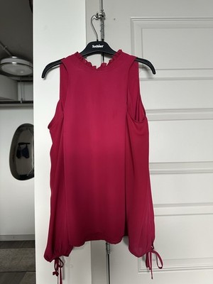 Add A Pop of Bold Color to Your Wardrobe with This Elegant Fuchsia Blouse.