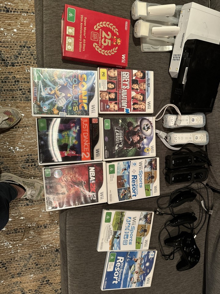 2x Nintendo Wii Consoles And Controls + 8 Games Inc.Super Mario 25th