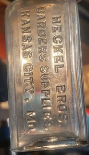HECKEL BROS BARBERS SUPPLIES KANSAS CITY MISSOURI EMBOSSED MEDICINE STYLE BOTTLE