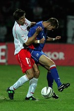 Grzegorz Rasiak of Poland tackles Gretar Rafn Steinsson of Icelan- 2005 Photo