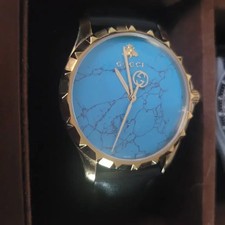 Gucci Turquoise Men's Watch with Gold Bezel and Black Leather Strap