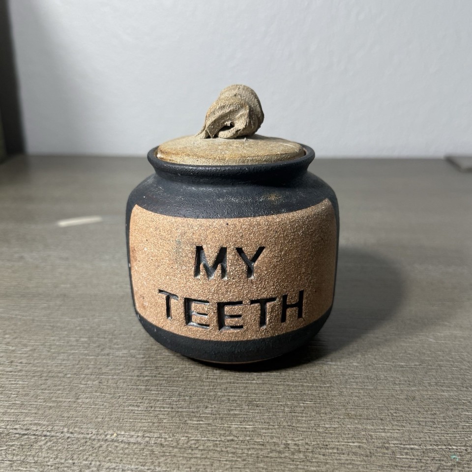 A studio pottery jar literally labeled 'My Teeth' — handmade, humorous, and the most on-brand denture storage vessel ever conceived.