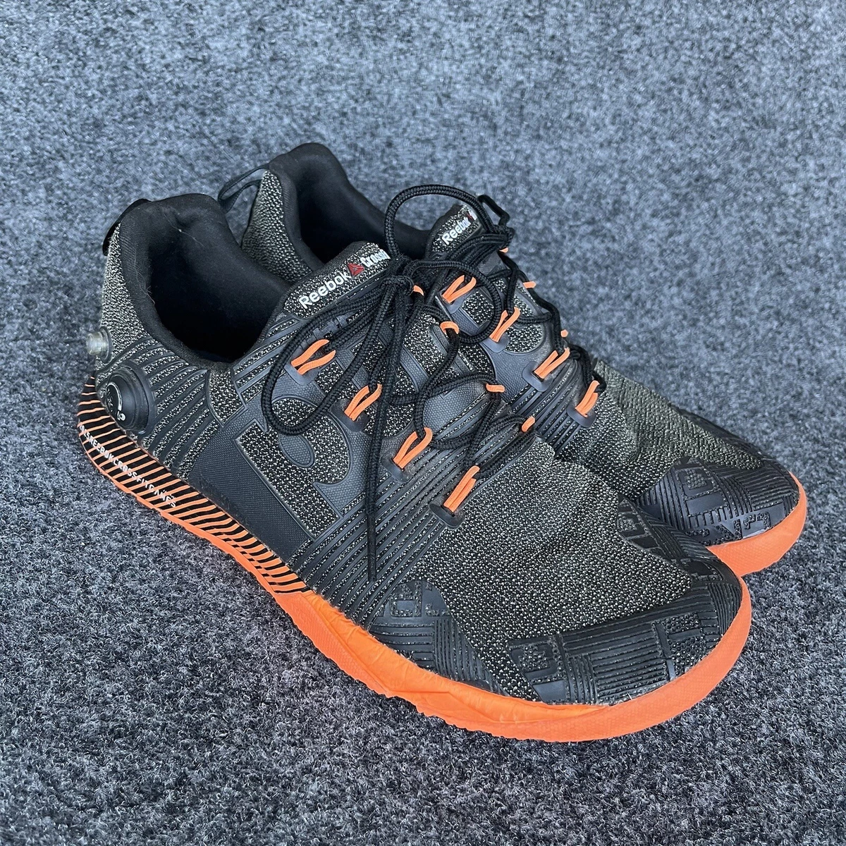 Reebok black store orange shoes