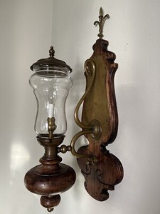 A large wall lamp made of retro wood, copper and glass