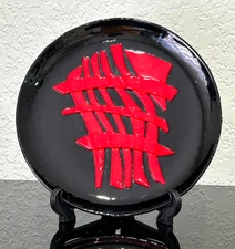 Vintage Decorative Ceramic Black Glazed Plate with a Raised Red Abstract Design.