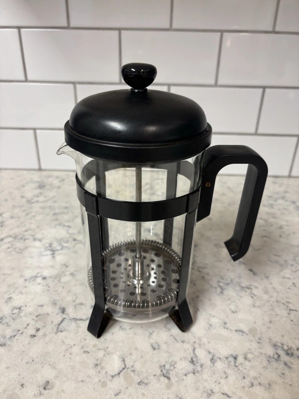 Melior French press coffee maker with a glass carafe and black handle.